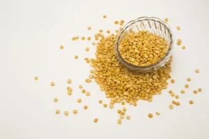 Yellow split peas in a glass bowl, used to illustrate pea protein