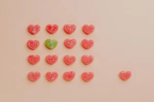 A picture displaying one differentcandy near lots of identical ones. The meaning is that it is okay to be different.